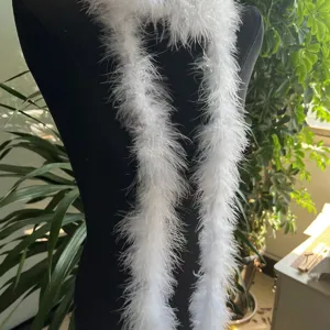Detailed view of fluffy white feather boa, perfect for wedding decoration and party use.