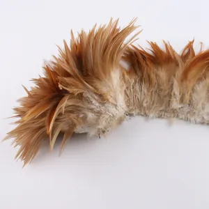 Close-up detail of brown-tipped feather trim, perfect for DIY crafts and clothing accessories.