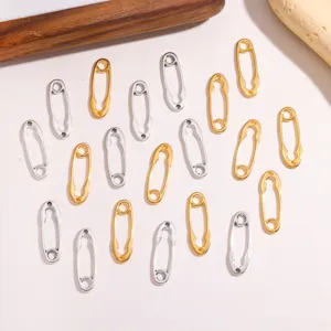 Detail view of DIY alloy safety pin jewelry charms, featuring gold and silver vintage pendant.