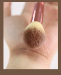 Close-up detail of soft fluffy makeup brush bristles, perfect for precise highlighting.
