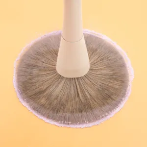 Large makeup powder brush with soft synthetic bristles and beige handle for professional beauty.