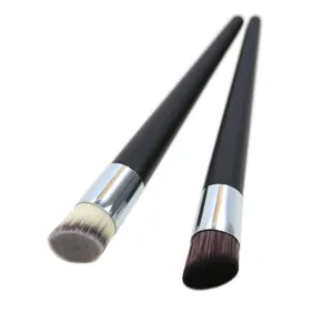 Detailed close-up of angled foundation makeup brushes with soft bristles and sleek handles.