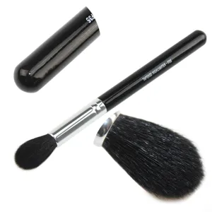 Close-up detail of the black tapered highlighter makeup brush with silver ferrule.