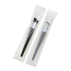 Detailed shot of professional angled and flat foundation makeup brushes in clear packaging bags.