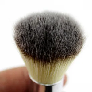 Close-up detail view of professional dual-ended makeup brush with soft dense gradient bristles.