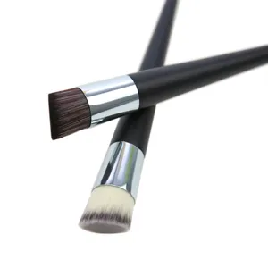 Detailed shot of angled foundation brush with sleek black handle and soft synthetic bristles.