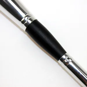 Close-up detail of double-ended makeup brush handle featuring metallic silver and matte black.