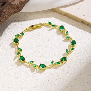 Close-up detail of the elegant green zircon leaf vine gold-plated bracelet texture.