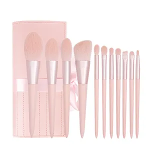 11-piece pink makeup brush set with portable leather roll pouch for professional beauty.