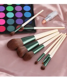 Detailed view of an 8-piece makeup brush set with green handles and soft bristles.