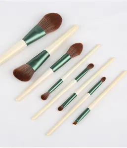 Professional 8-piece makeup brush set with soft synthetic bristles and green handles tool.