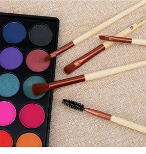 Bamboo handle makeup brush set with colorful eyeshadow palette for professional daily beauty use.