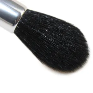Professional makeup highlighter brush with soft goat hair and silver ferrule for face.