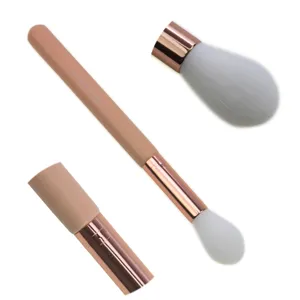Detailed view of the soft white bristle makeup brush with a nude handle and rose gold ferrule.