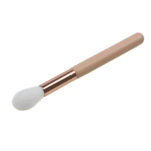 Professional tapered highlighter makeup brush with soft white bristles and rose gold ferrule.