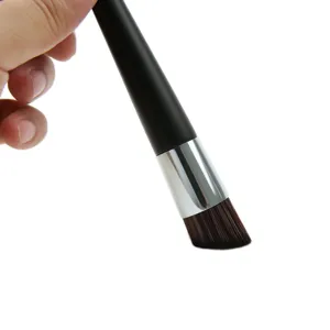 Angled foundation brush for liquid makeup, flawless blending tool for smooth application.