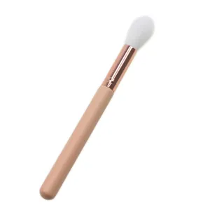 Single highlighter makeup brush with soft white bristles and rose gold ferrule for face detail.