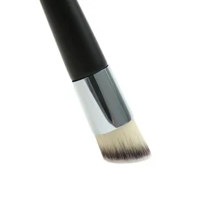 Angled foundation brush close-up, synthetic bristles, silver ferrule, black handle.