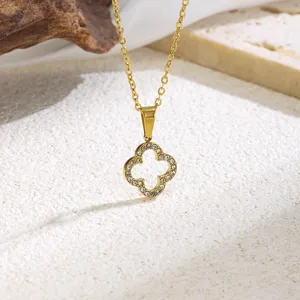 Close-up detail of the elegant gold four-leaf clover zircon pendant necklace sparkling nicely.