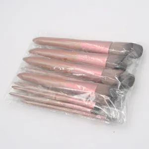 Detailed view of the 12-piece brown makeup brush set in transparent plastic packaging.