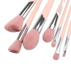 Detailed close-up view of soft pink makeup brush bristles and metallic ferrules.