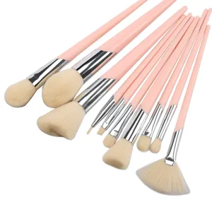 Close up view of soft synthetic bristles and pink handles on professional makeup brush set detail.