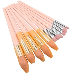 Pink makeup brush set detail, soft bristles with protective net sleeves, smooth long handles.