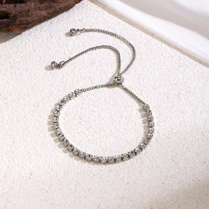 Detailed shot of a delicate silver tennis bracelet with sparkling stones and adjustable slider.