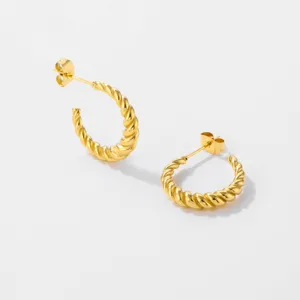 Gold stainless steel twisted C shape hoop earrings close up detail shot trendy jewelry