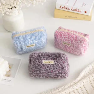 Close-up detail of cute fluffy leopard print cosmetic pouch, soft plush makeup bag and pencil case.