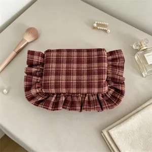 Vintage plaid cosmetic bag with elegant ruffles, stylish portable makeup storage pouch.