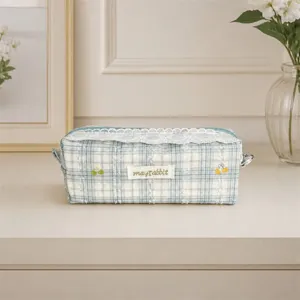Detailed view of the sweet blue plaid pencil case featuring delicate white lace and cute embroidery.