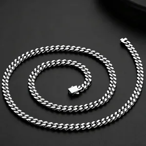Detail shot of silver stainless steel cuban link chain showing clasp and links.