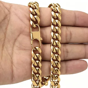 Close-up detail of a thick gold plated cuban link chain necklace showing polished metal links.