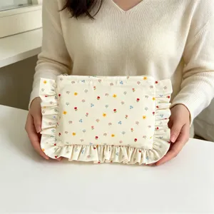 Charming floral ruffle cosmetic pouch with soft fabric design, ideal for daily makeup storage.