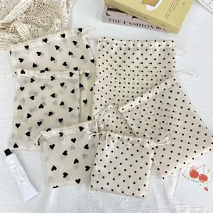Champagne organza drawstring storage bags with cute heart and polka dot prints for cosmetics.
