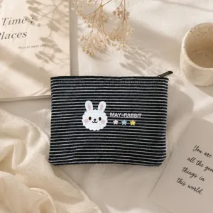 Detailed view of black white striped canvas pouch with cute rabbit print, ideal pencil bag.