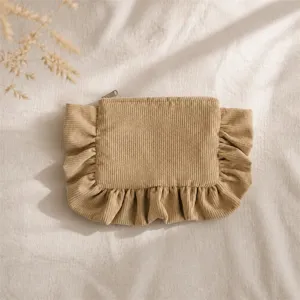 Close-up detail of the cute corduroy ruffle makeup pouch, showing fine textured fabric.