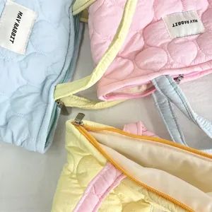 Soft quilted handbag detail, cute pastel color bento storage bag for women commute.