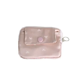 Pink mini coin purse with white bow print, cute card holder and portable key ring organizer.