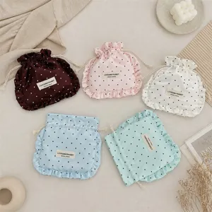 Satin polka dot drawstring pouch with ruffle design, cute storage bag for jewelry and makeup.
