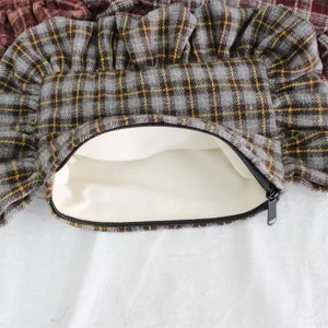 Detailed view of retro plaid ruffled cosmetic bag showing inner lining and texture.