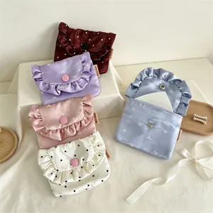 Detail view of Korean style satin ruffled flap coin purse set with cute bow and polka dot prints.