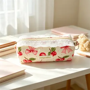 Detailed view of the Korean floral lace pencil case with cute cherry and bow pattern.