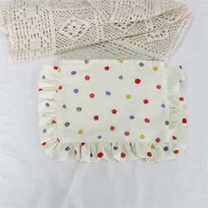 Cute polka dot cosmetic pouch with sweet ruffle edge, soft fabric daily makeup storage bag detail.