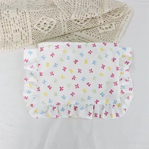 Detail view of the cute floral ruffle cosmetic bag, soft fabric storage pouch for daily use.