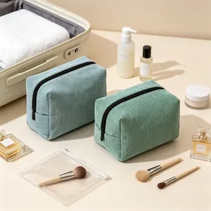 Corduroy cosmetic bag detail showing soft texture, ample space and sturdy black zipper.
