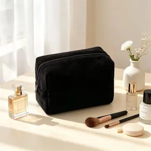 Black corduroy cosmetic bag detail, soft texture travel makeup organizer with zipper.