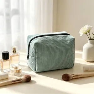 Green corduroy makeup bag detail, soft texture fabric, portable daily travel cosmetic storage.