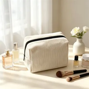 Beige corduroy makeup bag detail, cozy lifestyle display with perfume and brushes.